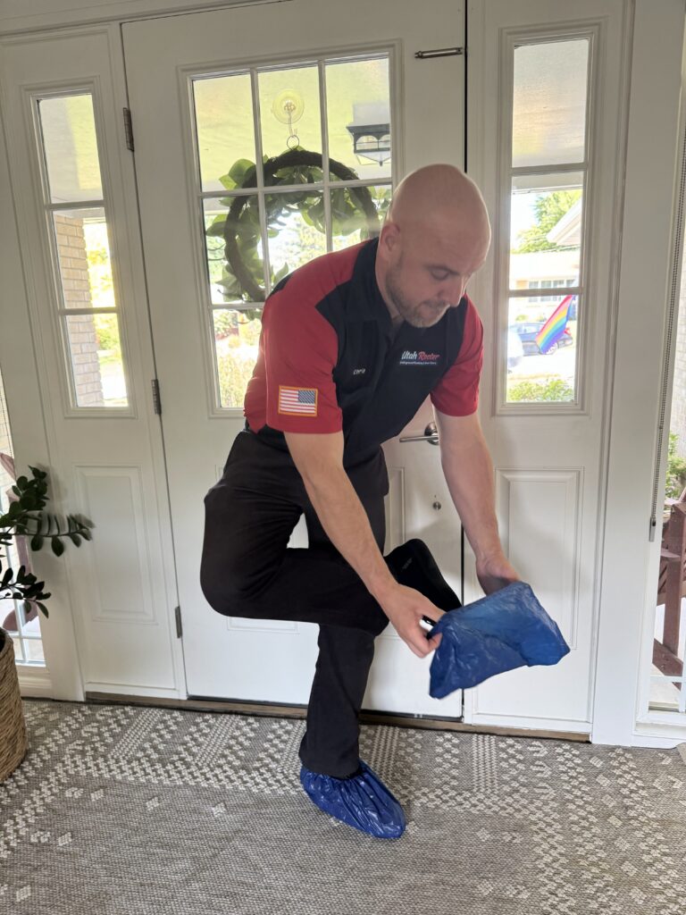 Utah Rooter Plumbers Pro Putting on shoe boots